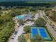 Community tennis courts and clubhouse with pool at 9609 Brookdale Dr, New Port Richey, FL 34655