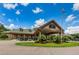 Clubhouse exterior with golf carts and landscaping at 9609 Brookdale Dr, New Port Richey, FL 34655