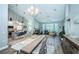 Open concept dining room with large table, hardwood floors, and access to kitchen at 9609 Brookdale Dr, New Port Richey, FL 34655
