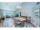 Bright dining room with a farmhouse-style table and access to the living room at 9609 Brookdale Dr, New Port Richey, FL 34655