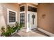 Inviting front entrance with a white door, potted plants, and decorative wreath at 9609 Brookdale Dr, New Port Richey, FL 34655
