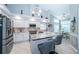 Updated kitchen with granite countertops, stainless steel appliances, and island at 9609 Brookdale Dr, New Port Richey, FL 34655