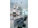 Modern kitchen featuring granite island, stainless steel appliances, and white cabinets at 9609 Brookdale Dr, New Port Richey, FL 34655