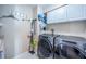 Bright laundry room with washer, dryer, and ample storage at 9609 Brookdale Dr, New Port Richey, FL 34655