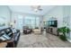 Relaxing living room with leather furniture, wood-look floors, and a large TV at 9609 Brookdale Dr, New Port Richey, FL 34655