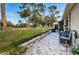 Spacious patio with brick pavers, lush landscaping, and golf course views at 9609 Brookdale Dr, New Port Richey, FL 34655