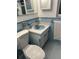 Clean bathroom with light blue tile and vanity at 1050 Tamarac Dr, Holiday, FL 34690