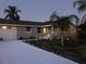 Ranch style home with a large driveway and mature landscaping at 1050 Tamarac Dr, Holiday, FL 34690