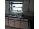 Galley kitchen with ample counter space and cabinets at 1050 Tamarac Dr, Holiday, FL 34690