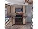 Kitchen with electric range and microwave at 1050 Tamarac Dr, Holiday, FL 34690