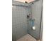 Shower stall with light blue tile walls at 1050 Tamarac Dr, Holiday, FL 34690