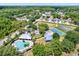 Aerial view of community amenities including pool, tennis courts, and playground at 10724 Burning Bush Ter, Land O Lakes, FL 34638