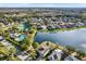 Aerial view of community with lake, pool, and tennis court at 10724 Burning Bush Ter, Land O Lakes, FL 34638