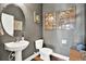 Stylish bathroom with pedestal sink, toilet, and wood-look flooring at 10724 Burning Bush Ter, Land O Lakes, FL 34638