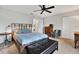 Cozy bedroom with a wooden platform bed and a ceiling fan at 10724 Burning Bush Ter, Land O Lakes, FL 34638