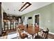 Farmhouse dining area with a long wooden table and kitchen access at 10724 Burning Bush Ter, Land O Lakes, FL 34638