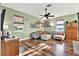 Living room with hardwood floors, L-shaped sofa, and a wall gallery at 10724 Burning Bush Ter, Land O Lakes, FL 34638