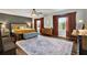 Spacious main bedroom with a king-size bed and lots of natural light at 10724 Burning Bush Ter, Land O Lakes, FL 34638