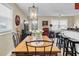 Farmhouse style dining area with wood table and black metal chairs at 11617 Boynton Ln, New Port Richey, FL 34654