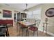 Dining area with rustic wood table, black chairs and a window with blinds at 11617 Boynton Ln, New Port Richey, FL 34654