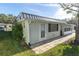 Single story home with metal roof and patio at 11617 Boynton Ln, New Port Richey, FL 34654