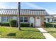Inviting condo exterior, featuring a gray metal roof and well-manicured lawn at 11617 Boynton Ln, New Port Richey, FL 34654