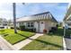 Tan building with metal roof, and a white door at 11617 Boynton Ln, New Port Richey, FL 34654