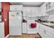 Bright kitchen featuring white cabinets and stainless steel appliances at 11617 Boynton Ln, New Port Richey, FL 34654