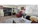 Living room with a large TV, comfortable seating, and hardwood floors at 11617 Boynton Ln, New Port Richey, FL 34654
