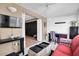 Sunroom with red couch and workspace at 11617 Boynton Ln, New Port Richey, FL 34654
