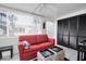 Sunroom with red couch and storage at 11617 Boynton Ln, New Port Richey, FL 34654