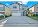 Two-story house with gray siding, white garage door, and landscaping at 13315 Marble Sands Ct, Hudson, FL 34669