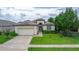 One story house with a large front yard and driveway at 13455 Niti Dr, Hudson, FL 34669
