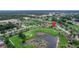 House nestled in a golf course community near a pond at 13455 Niti Dr, Hudson, FL 34669