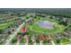 Aerial view showcasing a home's location near a golf course and pond at 13455 Niti Dr, Hudson, FL 34669