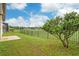 Landscaped backyard with a view of the golf course and privacy fence at 13455 Niti Dr, Hudson, FL 34669