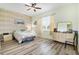 Comfortable bedroom with wood-look floors and ceiling fan at 13455 Niti Dr, Hudson, FL 34669