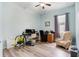 Bright bedroom with wood-look floors, built-in desk, and comfortable seating at 13455 Niti Dr, Hudson, FL 34669