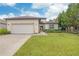 One-story home with a two-car garage and well-maintained lawn at 13455 Niti Dr, Hudson, FL 34669