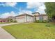 House exterior featuring a garage and manicured lawn at 13455 Niti Dr, Hudson, FL 34669