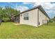 Well-maintained house exterior with a screened patio and lush lawn at 13455 Niti Dr, Hudson, FL 34669