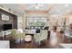 Open concept living room and kitchen with hardwood floors and view to backyard at 13455 Niti Dr, Hudson, FL 34669