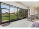 Spacious screened porch with multiple seating options and a view of the backyard at 13455 Niti Dr, Hudson, FL 34669