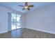 Bright bedroom with tile floor and sliding glass door leading to the pool at 13541 Stacey Dr, Hudson, FL 34667
