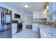 Modern kitchen with stainless steel appliances and granite countertops at 13541 Stacey Dr, Hudson, FL 34667