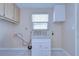 Laundry room with white cabinets and granite countertop at 13541 Stacey Dr, Hudson, FL 34667