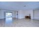 Bright living room with tile flooring and sliding doors leading to the pool at 13541 Stacey Dr, Hudson, FL 34667