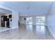 Open living room with kitchen access and pool view at 13541 Stacey Dr, Hudson, FL 34667