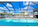 Inviting screened pool with water feature and canal view at 13541 Stacey Dr, Hudson, FL 34667