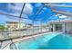 Refreshing screened pool with water feature and backyard view at 13541 Stacey Dr, Hudson, FL 34667